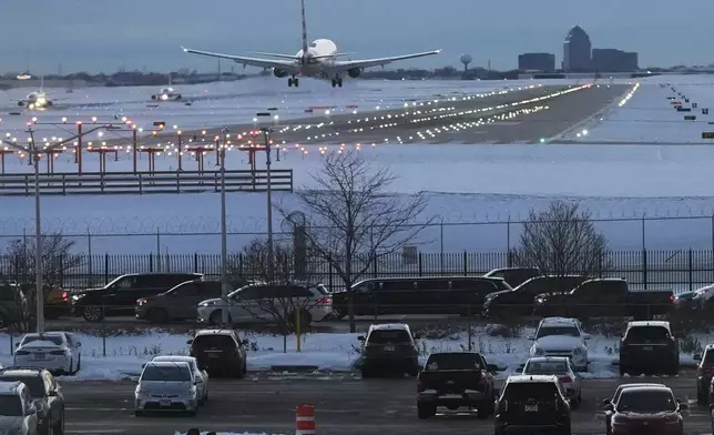 An American airplane arrives at the O'Hare International Airport in Chicago, Sunday, Nov. 30, 2025. (AP Photo/Nam Y. Huh)