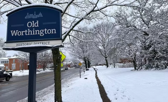 Snow accumulates in Worthington, Ohio, Tuesday, Dec. 2, 2025. (AP Photo/Julie Carr Smyth)