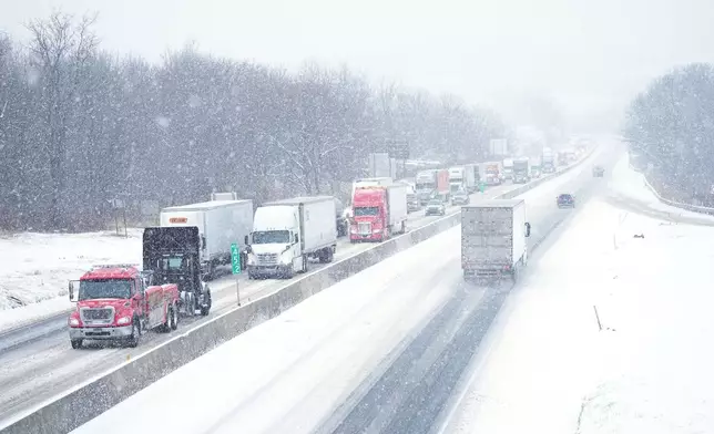 Vehicles slowly move during a storm on Interstate 78 in Kutztown, Pa., Tuesday, Dec. 2, 2025. (AP Photo/Matt Rourke)