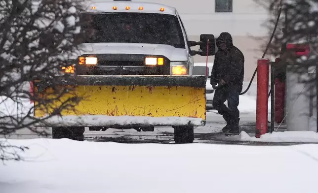 A man fills up a vehicle's gas tank at a gas station in Buffalo Grove, Ill., Monday, Dec. 1, 2025. (AP Photo/Nam Y. Huh)