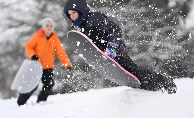 Luke Moot hits a ramp during a snow day at Berkley Hills Golf Course in Johnstown, Pa., after the region received its first significant snowfall of the season, Tuesday, Dec. 2, 2025. (John Rucosky/Tribune-Democrat via AP)