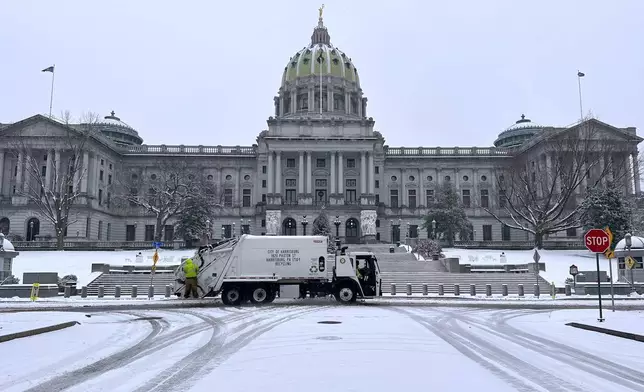 Snow blankets the steps of the Pennsylvania Capitol in Harrisburg, Pa., Tuesday, Dec. 2, 2025. (AP Photo/Marc Levy)