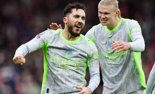 Manchester City's Rayan Cherki, left, celebrates with Erling Haaland after scoring his side's second goal during the Premier League match between Nottingham Forest and Manchester City, in Nottingham, England, Saturday Dec. 27, 2025. (Barrington Coombs/PA via AP)