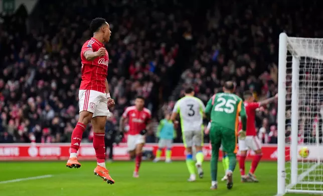 Nottingham Forest's Omari Hutchinson celebrates scoring his side's first goal during the Premier League match between Nottingham Forest and Manchester City, in Nottingham, England, Saturday Dec. 27, 2025. (Joe Giddens/PA via AP)