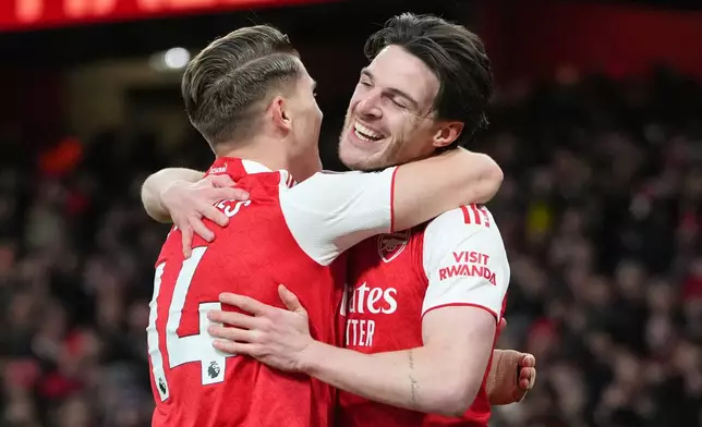 Arsenal's Viktor Gyoekeres and Arsenal's Declan Rice celebrate after Brighton's Georginio Rutter scored an own goal during the English Premier League soccer match between Arsenal and Brighton and Hove Albion in London, Saturday, Dec. 27, 2025. (AP Photo/Kirsty Wigglesworth)
