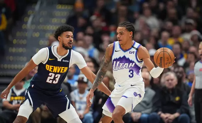 Utah Jazz guard Keyonte George, right, drives to the basket as Denver Nuggets forward Cameron Johnson, left, defends in the first half of an NBA basketball game Monday, Dec. 22, 2025, in Denver. (AP Photo/David Zalubowski)