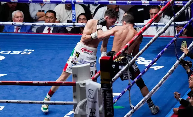 FILE - Mexico's David Picasso, left, and Armenia's Azat Hovhannisyan fight during their WBC Super Bantamweight Silver Voluntary boxing match at the Arena Mexico in Mexico City, Saturday, Aug. 24, 2024. (AP Photo/Eduardo Verdugo, File)
