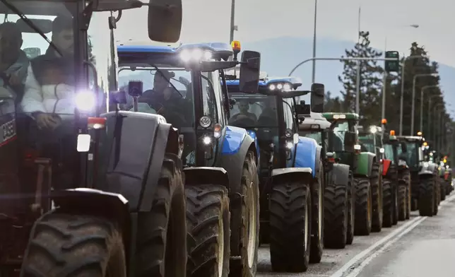 Farmers with their tractors try to block the main access road to Thessaloniki's international airport, northern Greece, Friday, Dec. 5, 2025, as protests over delays in European Union-backed agricultural subsidy payments escalated. (AP Photo/Giannis Papanikos)