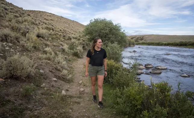 Heather Sterling hikes along the Green River, Aug. 11, 2025, near Daniel, Wyo. (AP Photo/Amber Baesler)