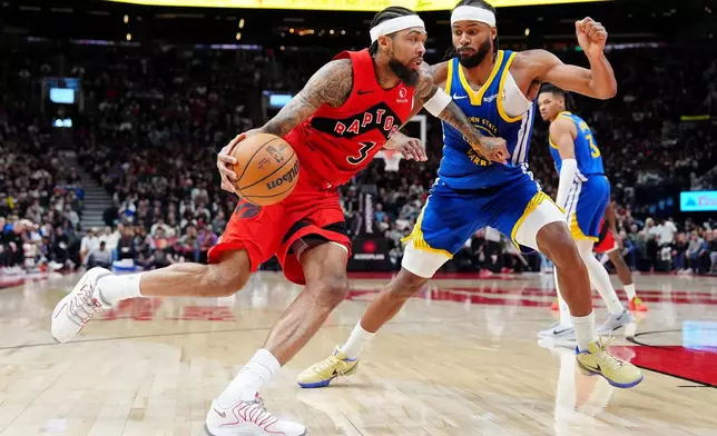 Toronto Raptors forward Brandon Ingram (3) commits an offensive foul against Golden State Warriors guard Moses Moody during the second half of an NBA basketball game in Toronto, Sunday, Dec. 28, 2025. (Frank Gunn/The Canadian Press via AP)