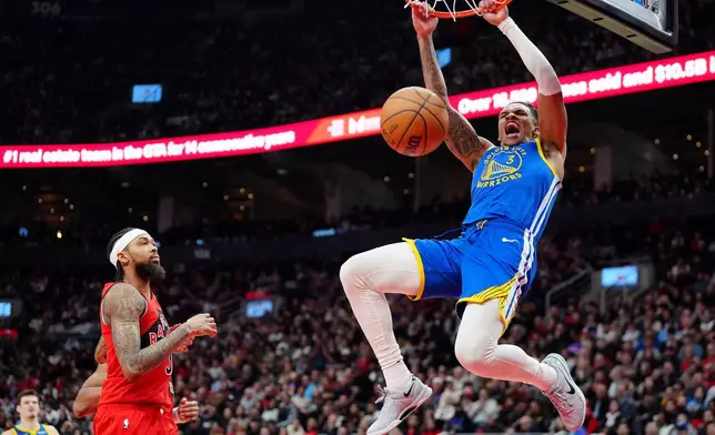 Golden State Warriors guard Will Richard (3) slam-dunks as Toronto Raptors forward Brandon Ingram, left, looks on during first-half NBA basketball game action in Toronto, Sunday, Dec. 28, 2025. (Frank Gunn/The Canadian Press via AP)