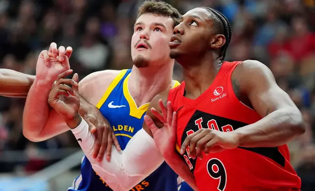 Golden State Warriors center Quinten Post, left, and Toronto Raptors forward RJ Barrett (9) watch for a rebound during first-half NBA basketball game action in Toronto, Sunday, Dec. 28, 2025. (Frank Gunn/The Canadian Press via AP)