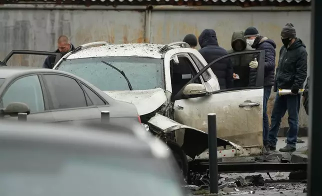 Investigators work at the scene where Lt. Gen. Fanil Sarvarov, head of the Operational Training Directorate of the Russian Armed Forces General Staff, was killed by an explosive device placed under his car in Moscow, Monday, Dec. 22, 2025. (AP Photo)