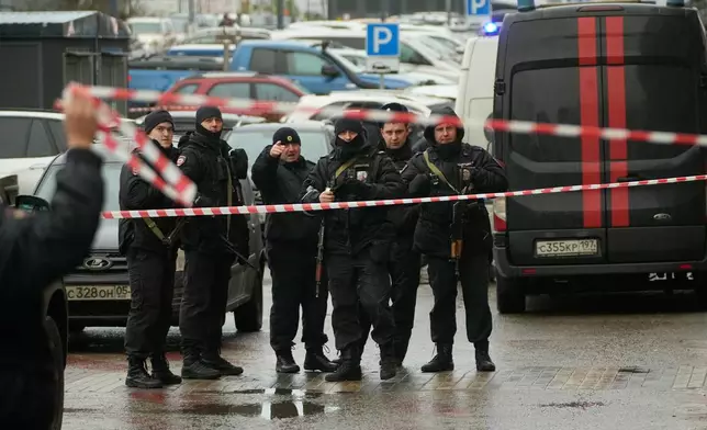 Policemen secure the area near the scene where Lt. Gen. Fanil Sarvarov, head of the Operational Training Directorate of the Russian Armed Forces General Staff, was killed by an explosive device placed under his car in Moscow, Monday, Dec. 22, 2025. (AP Photo)