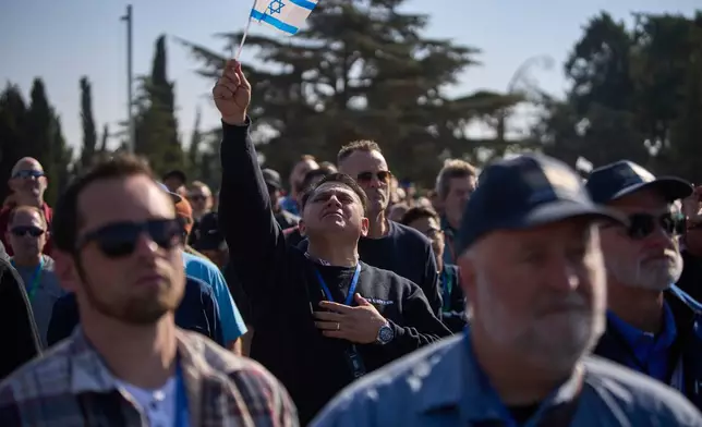 FILE - People pray as they visit at Mount Herzl military cemetery in Jerusalem, Dec. 4, 2025. (AP Photo/Ohad Zwigenberg, File)