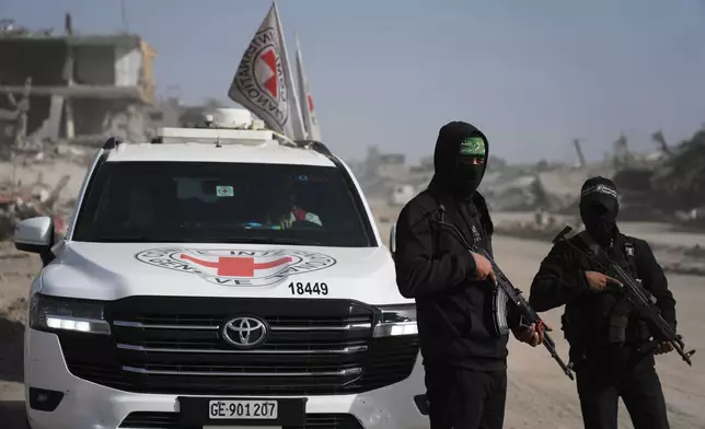 FILE - Hamas militants accompanied by members of the International Committee of the Red Cross (ICRC) head to Zeitoun neighborhood of Gaza City to search for the remains of deceased hostages, Dec. 8, 2025. (AP Photo/Jehad Alshrafi, File)