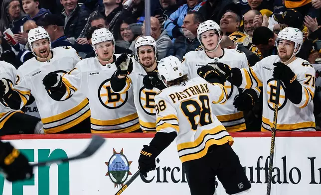 Boston Bruins' David Pastrnak (88) celebrates his goal against the Winnipeg Jets during first period NHL action in Winnipeg, Manitoba, on Thursday, Dec. 11, 2025. (John Woods/The Canadian Press via AP)