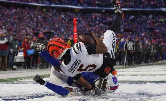Cincinnati Bengals wide receiver Tee Higgins (5) comes down with a touchdown catch as Buffalo Bills cornerback Tre'Davious White (27) defends during the second half of an NFL football game, Sunday, Dec. 7, 2025, in Orchard Park, N.Y. (AP Photo/Jeffrey T. Barnes)