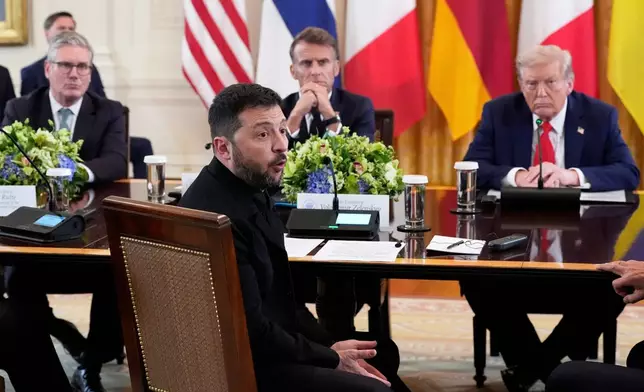 FILE - Ukraine's President Volodymyr Zelenskyy speaks as British Prime Minister Keir Starmer, seated from background left, France's President Emmanuel Macron and President Donald Trump listen during a meeting in the East Room of the White House, Aug. 18, 2025, in Washington. (AP Photo/Alex Brandon, File)