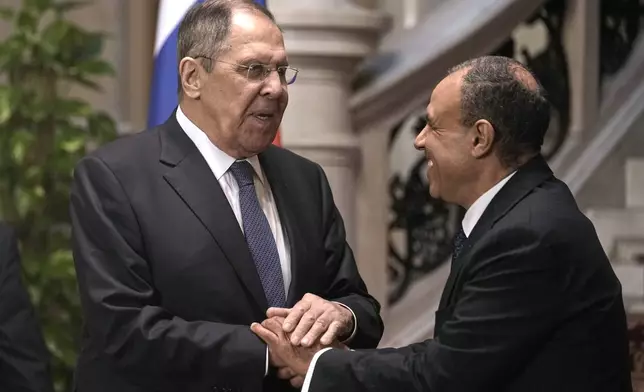 Russian Foreign Minister Sergey Lavrov, left, shakes hands with his Egyptian counterpart Badr Abdelatty, after their joint press conference at Tahrir Palace in Cairo, Egypt, Friday, Dec. 19, 2025. (AP Photo/Amr Nabil)