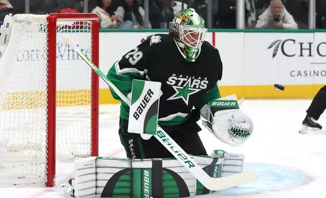 Dallas Stars goaltender Jake Oettinger blocks a shot during the second period of an NHL hockey game against the Pittsburgh Penguins, Sunday, Dec. 7, 2025, in Dallas. (AP Photo/Sam Hodde)