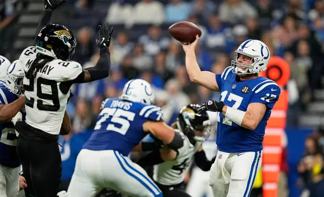 Indianapolis Colts quarterback Philip Rivers (17) throws under pressure from Jacksonville Jaguars safety Eric Murray (29) during the second half of an NFL football game Sunday, Dec. 28, 2025, in Indianapolis. (AP Photo/Carolyn Kaster)