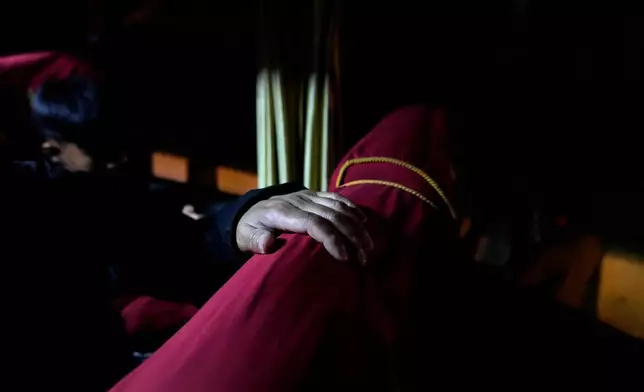 Sonam Tashi sits on a bus in New Delhi as it leaves for Dharamshala where he hopes the Tibetan government in exile there can help his son access education, March 5, 2025. (AP Photo/Manish Swarup)