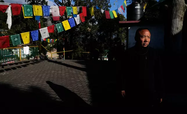 Sonam Tashi takes a walk in a temple at the Tibetan Children's Village school in Mcleodganj near Dharamshala, India, March 6, 2025. (AP Photo/Manish Swarup)
