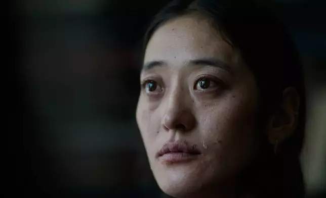 A tear rolls down the cheek of Namkyi, a Tibetan former political prisoner who was arrested at 15 an imprisoned for protesting Chinese rule, as she recounts her story during an interview at the Office of Tibet in Washington, Oct. 8, 2025. (AP Photo/David Goldman)