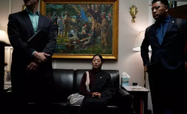 Namkyi, right, a Tibetan former political prisoner who was arrested at 15 for protesting Chinese rule, waits in the office of House Foreign Affairs Committee Chairman Michael McCaul, R-Texas, for a meeting with his staff while joined by Tsultrim Gyatso, right, China Director at Office of Tibet, in Washington, Oct. 8, 2025. (AP Photo/David Goldman)