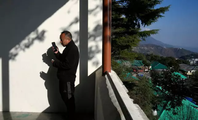 Sonam Tashi talks on his mobile phone from Tibetan Children's Village school in Mcleodganj near Dharamshala, India, March 6, 2025. (AP Photo/Manish Swarup)