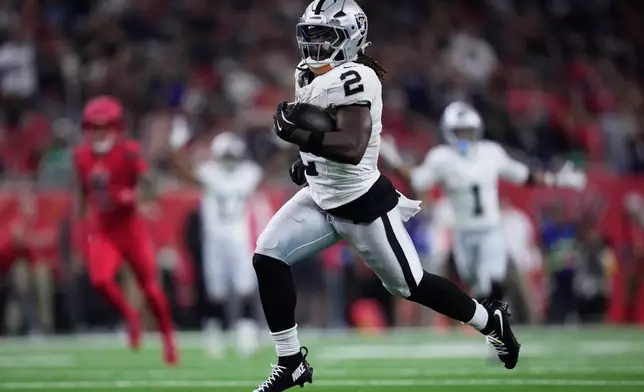 Las Vegas Raiders running back Ashton Jeanty (2) runs for a touchdown during the second half of an NFL football game against the Houston Texans, Sunday, Dec. 21, 2025, in Houston. (AP Photo/Ashley Landis)