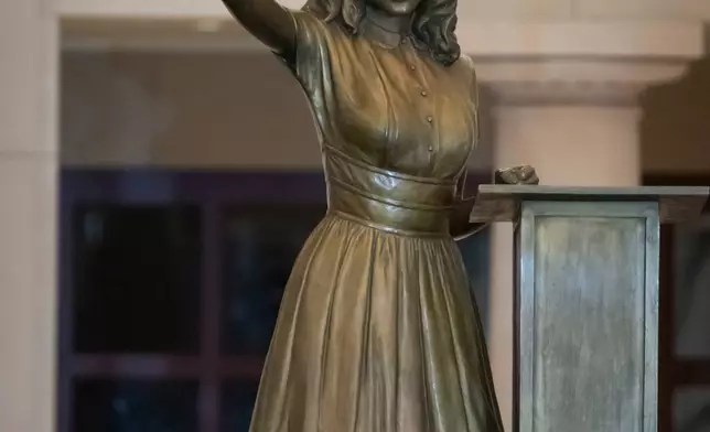 People take photos of a statue of Virginia civil rights activist Barbara Rose Johns, whose statue will replace one of Robert E. Lee as one of Virginia's two statues on display at the Capitol, at a dedication ceremony Tuesday, Dec. 16, 2025, in Washington. (AP Photo/Mark Schiefelbein)