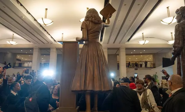 People take photos of a statue of Virginia civil rights activist Barbara Rose Johns, whose statue will replace one of Robert E. Lee as one of Virginia's two statues on display at the Capitol, at a dedication ceremony Tuesday, Dec. 16, 2025, in Washington. (AP Photo/Mark Schiefelbein)