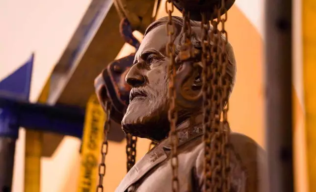 FILE - This Monday, Dec. 21, 2020 photo provided by the Office of the Governor of Virginia shows a statue of Confederate Gen. Robert E. Lee being removed from the National Statuary Hall Collection in Washington. (Jack Mayer/Office of Governor of Virginia, File)
