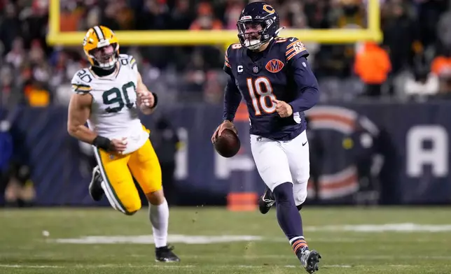 Chicago Bears' Caleb Williams gets away from Green Bay Packers' Lukas van Ness during the second half of an NFL football game Saturday, Dec. 20, 2025, in Chicago. (AP Photo/Nam Huh)