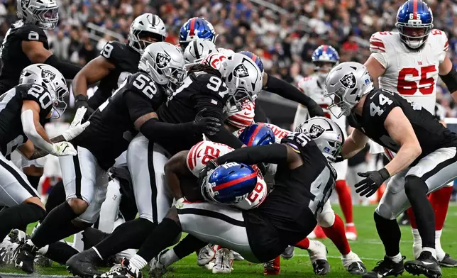 New York Giants running back Devin Singletary (26) scores touchdown against the Las Vegas Raiders during the first half of an NFL football game Sunday, Dec. 28, 2025, in Las Vegas. (AP Photo/David Becker)