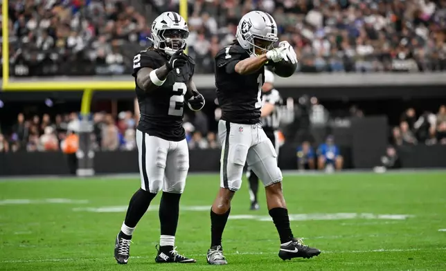 Las Vegas Raiders wide receiver Tre Tucker (1) celebrates his catch with running back Ashton Jeanty (2) during the first half of an NFL football game against the New York Giants Sunday, Dec. 28, 2025, in Las Vegas. (AP Photo/David Becker)