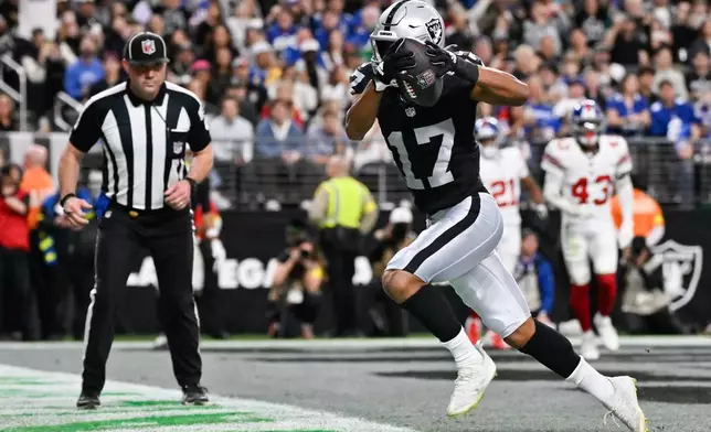 Las Vegas Raiders wide receiver Tyler Lockett (17) scores a touchdown during the second half of an NFL football game against the New York Giants Sunday, Dec. 28, 2025, in Las Vegas. (AP Photo/David Becker)