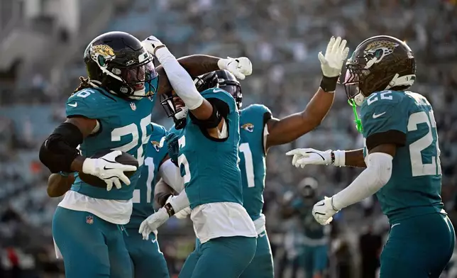 Jacksonville Jaguars safety Antonio Johnson (26) celebrates an interception against the New York Jets during the second half of an NFL football game, Sunday, Dec. 14, 2025, in Jacksonville, Fla. (AP Photo/Phelan M. Ebenhack)