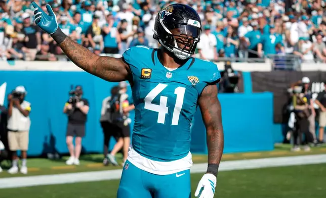 Jacksonville Jaguars defensive end Josh Hines-Allen reacts after an interception during the first half of an NFL football game against the New York Jets, Sunday, Dec. 14, 2025, in Jacksonville, Fla. (AP Photo/John Raoux)
