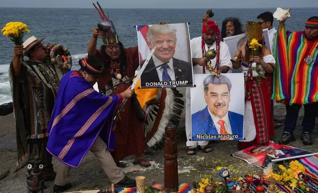 Shamans hold photos of U.S. President Donald Trump and Venezuela's President Nicolas Maduro during their annual ritual to predict political and social issues for the new year in Lima, Peru, Monday, Dec. 29, 2025. (AP Photo/Guadalupe Pardo)