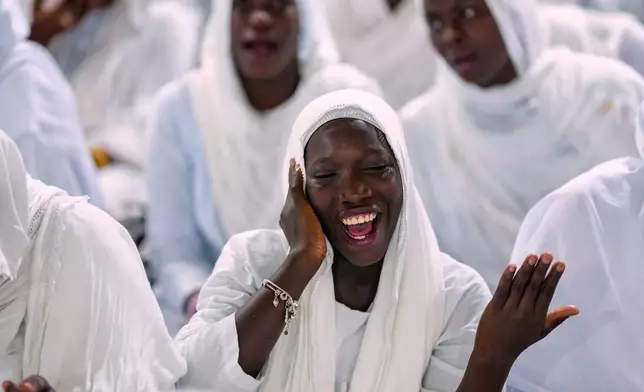 A woman recites prayers as people mark Prophet Muhammad's birthday, known as Mawlid, in Dakar, Senegal, Sept. 5, 2025. (AP Photo/Misper Apawu, File)