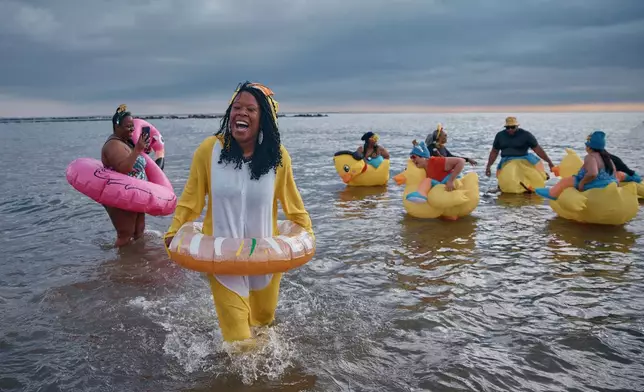 Revelers in costumes enter the cold water during the annual Polar Bear Plunge on New Year's Day, Jan. 1, 2025, in New York. (AP Photo/Andres Kudacki, File)