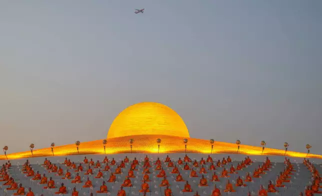 Thai Buddhist monks pray as they gather at Wat Dhammakaya temple to participate in Makha Bucha Day ceremonies in Pathum Thani, Thailand, Feb. 12, 2025. (AP Photo/Sakchai Lalit, File)