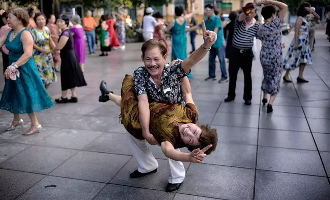 A Vietnamese couple practices Ballroom dancing as part of their morning exercise along Hoan Kiem Lake in Hanoi, Vietnam, May 2, 2025. (AP Photo/Richard Vogel, File)
