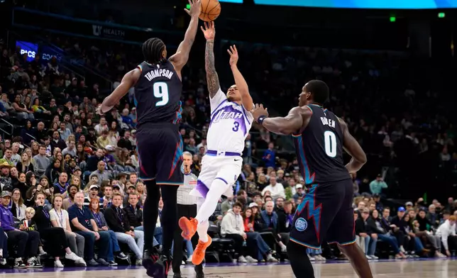 Utah Jazz guard Keyonte George (3) shoots over Detroit Pistons guard Ausar Thompson (9) during the second half of an NBA basketball game, Friday, Dec. 26, 2025, in Salt Lake City. (AP Photo/Tyler Tate)
