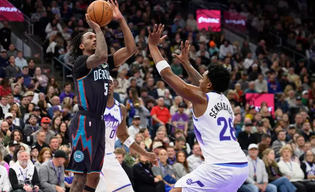 Detroit Pistons forward Ronald Holland II (5) shoots over Utah Jazz forward Brice Sensabaugh (28) during the first half of an NBA basketball game Friday, Dec. 26, 2025, in Salt Lake City. (AP Photo/Tyler Tate)