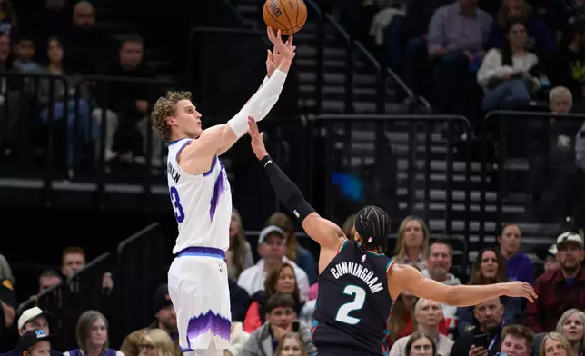Utah Jazz forward Lauri Markkanen, left, shoots over Detroit Pistons guard Cade Cunningham (2) during the first half of an NBA basketball game, Friday, Dec. 26, 2025, in Salt Lake City. (AP Photo/Tyler Tate)