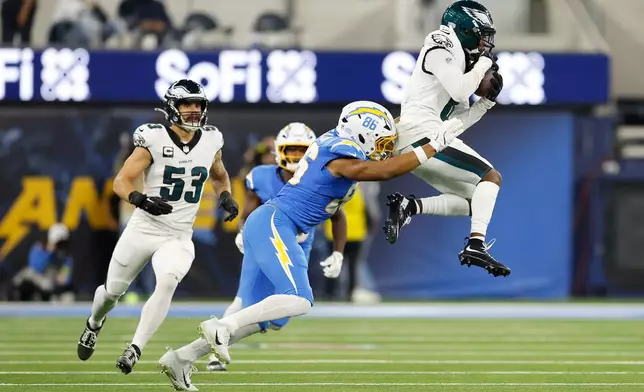 Philadelphia Eagles cornerback Adoree' Jackson (8) intercepts a pass intended for Los Angeles Chargers tight end Oronde Gadsden II (86) during the first half of an NFL football game Monday, Dec. 8, 2025, in Inglewood, Calif. (AP Photo/Caroline Brehman)
